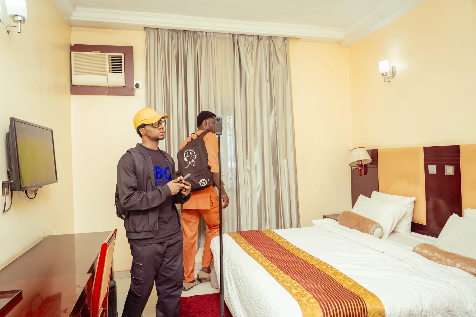 Best Quarters team capturing a furnished room using a 360-degree camera